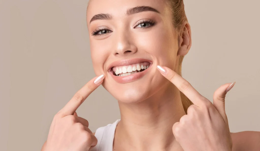 happy after getting professional teeth whitening from the Best Cosmetic in Dentist Boca Raton