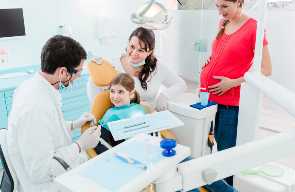 Child having her teeth checked by a dentist in west boca