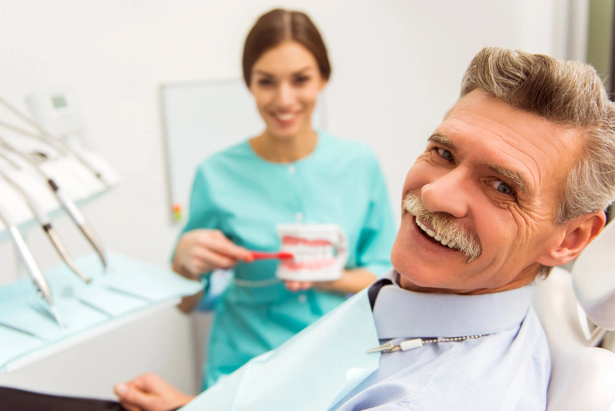 Senior man smiling after hybrid dentures boca raton