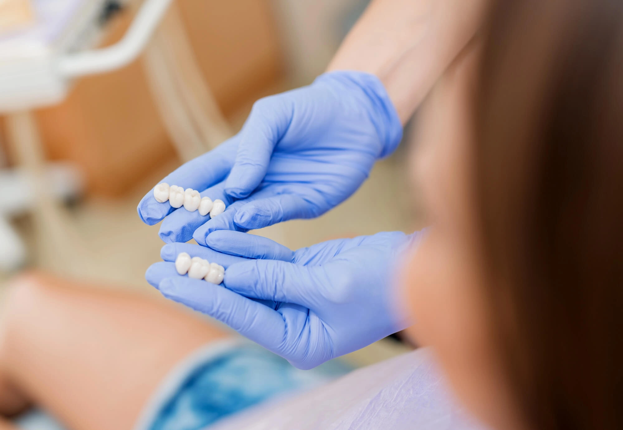 Dentist showing woman dental crowns boca raton