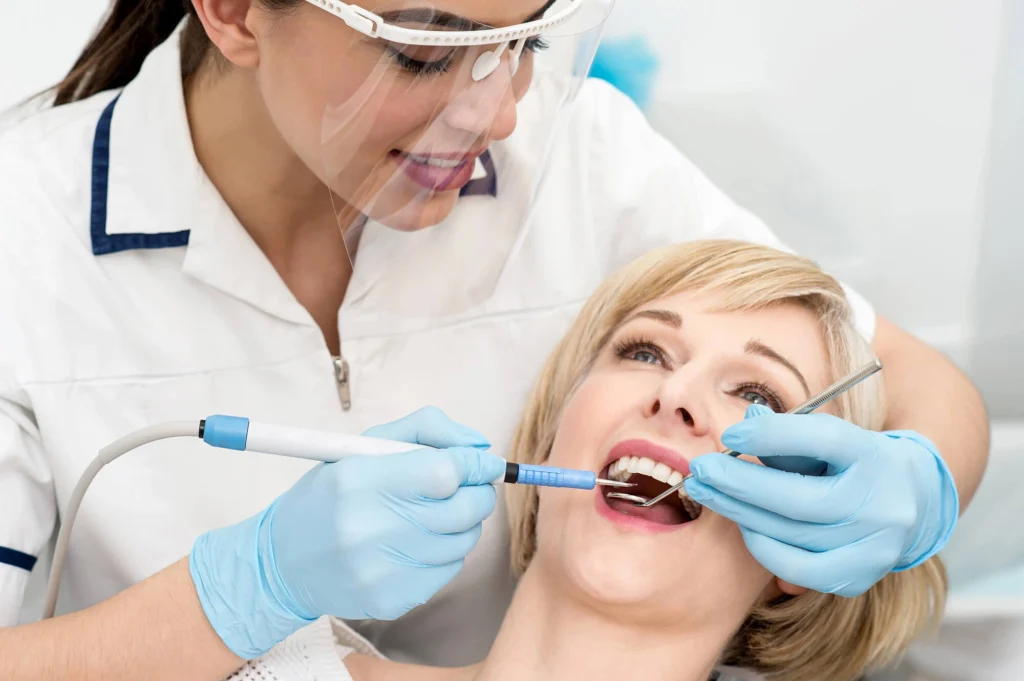 Woman undergoing treatment by best cosmetic dentist boca raton